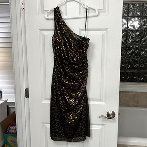 Black cocktail dress with gold polka dots